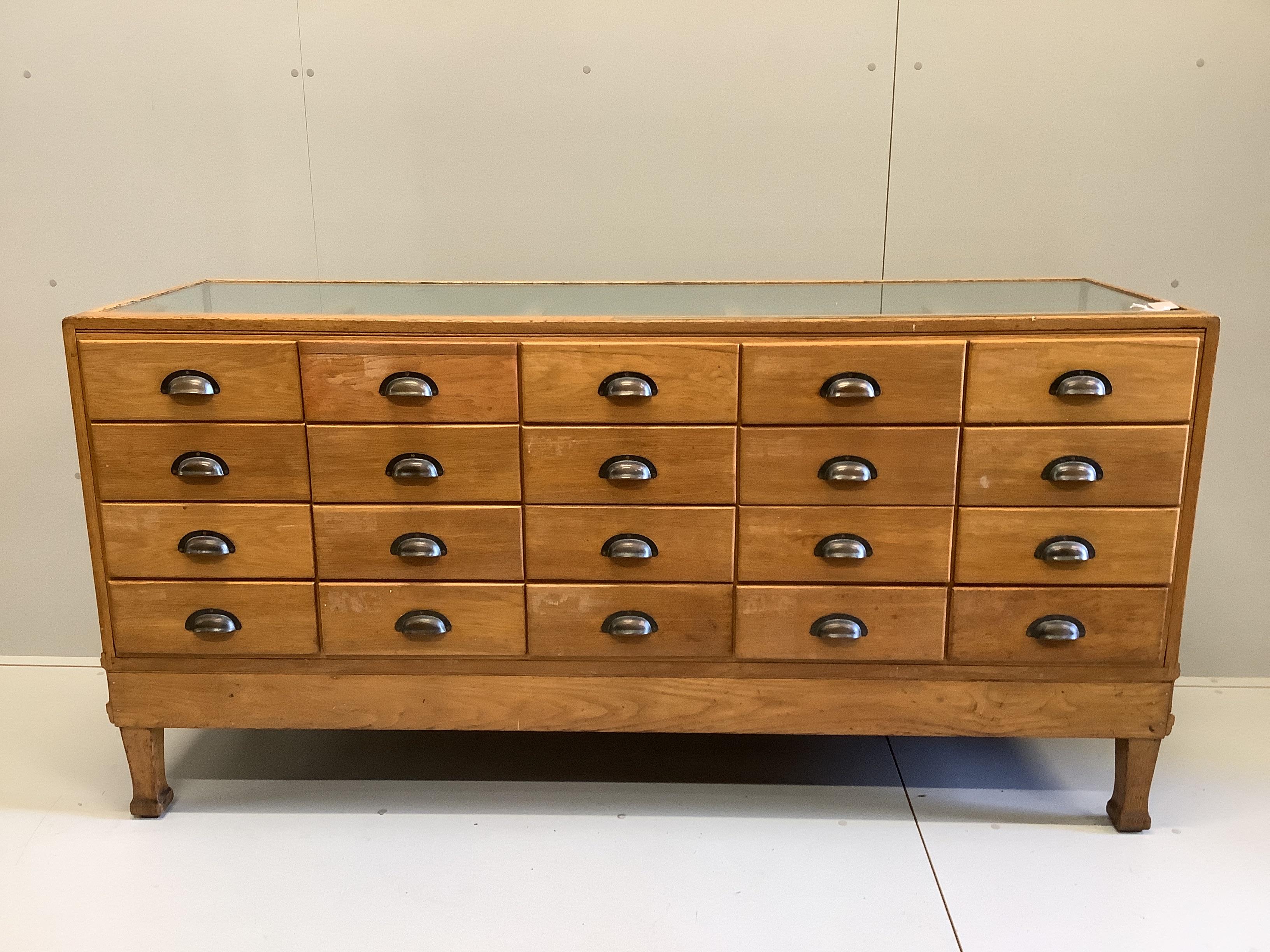 An early 20th century oak haberdashery cabinet, width 180cm, depth 58cm, height 91cm